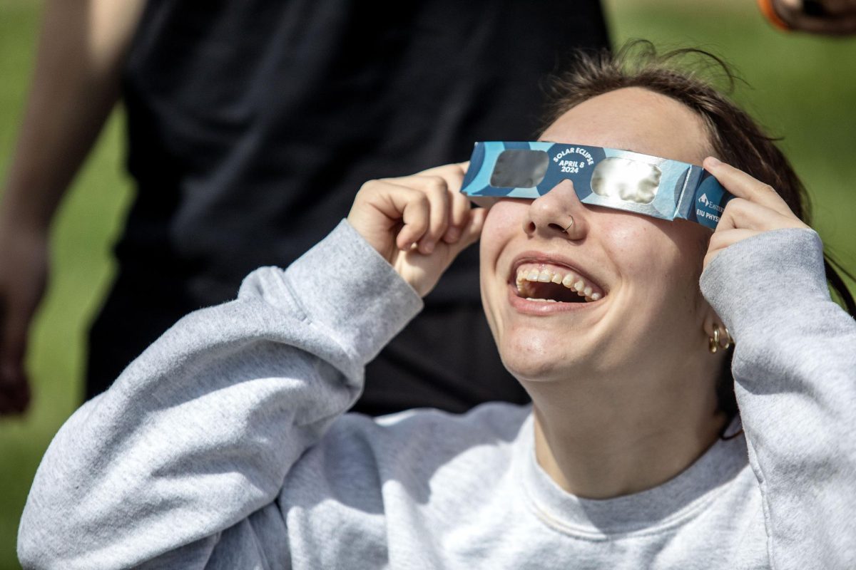 Brooklyn Konieczki, a junior psychology major, looks up at the solar eclipse Monday afternoon at the campus observatory.