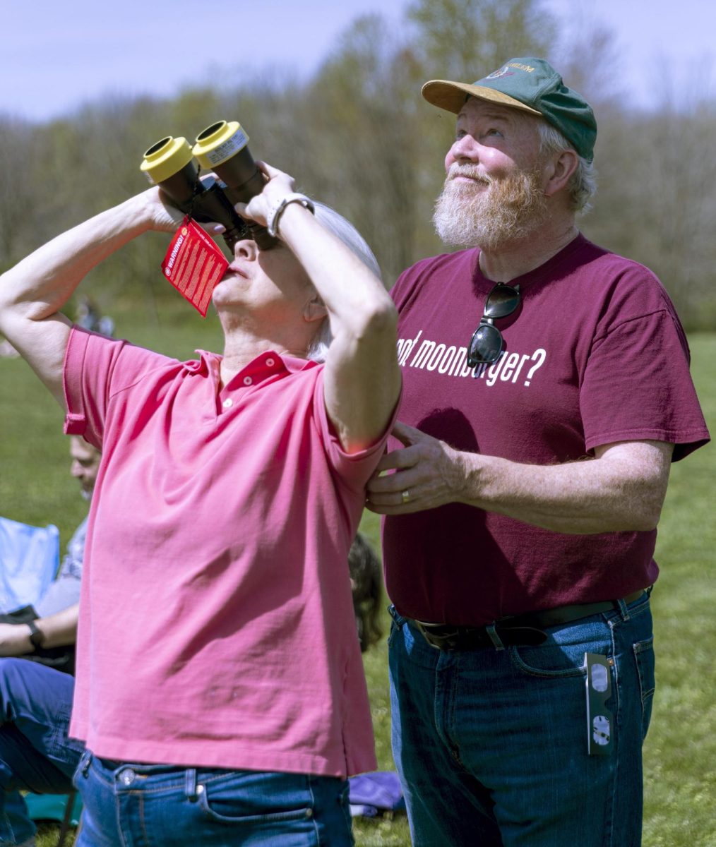 From left, Gail Mason, Democrat for Coles County Board, and Tim Mason, an associate professor in economics, watch the solar eclipse together at Robinson High School on Monday afternoon.