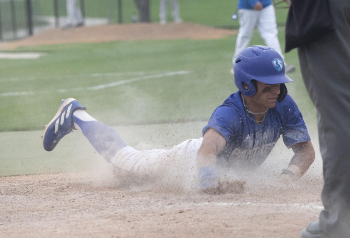 Junior outfield Quade Peters, Sliding into home base against  Bradley University Tuesday,