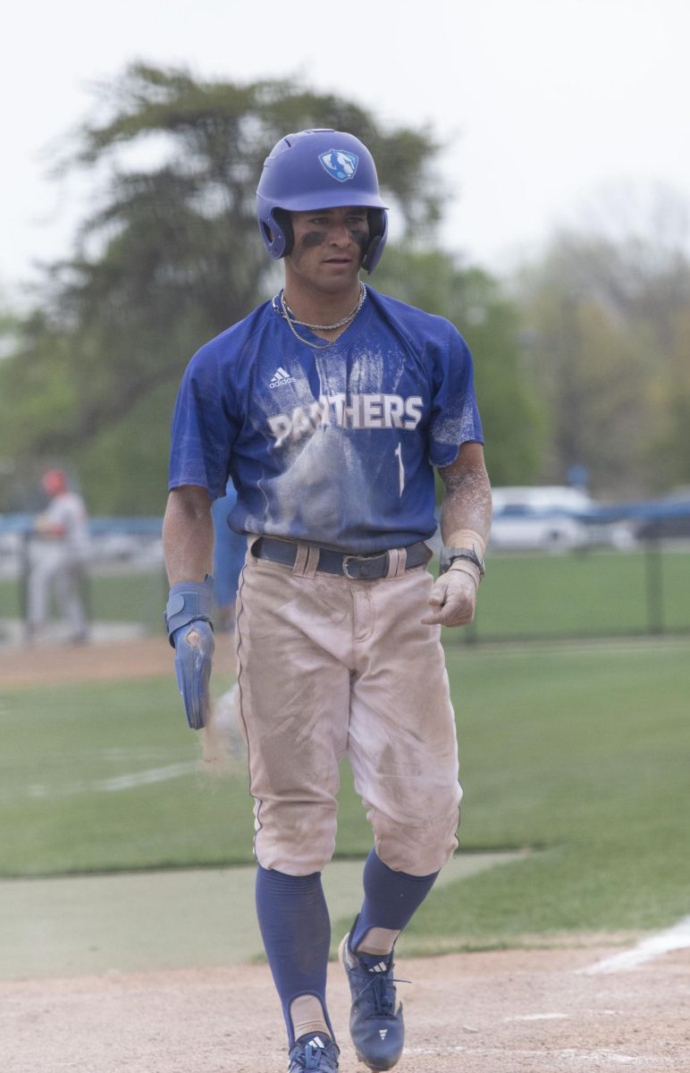 Junior outfield Quade Peters, covered in dirt after sliding into home base against  Bradley University Tuesday
