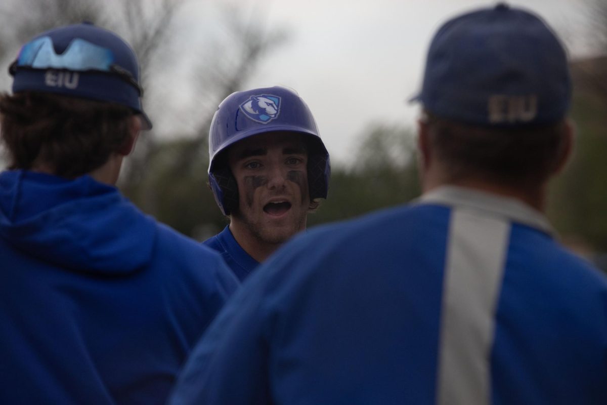 Junior Outfield (1) Quade Peters join the team in excitedment after sliding into home base  at the game against Bradley 