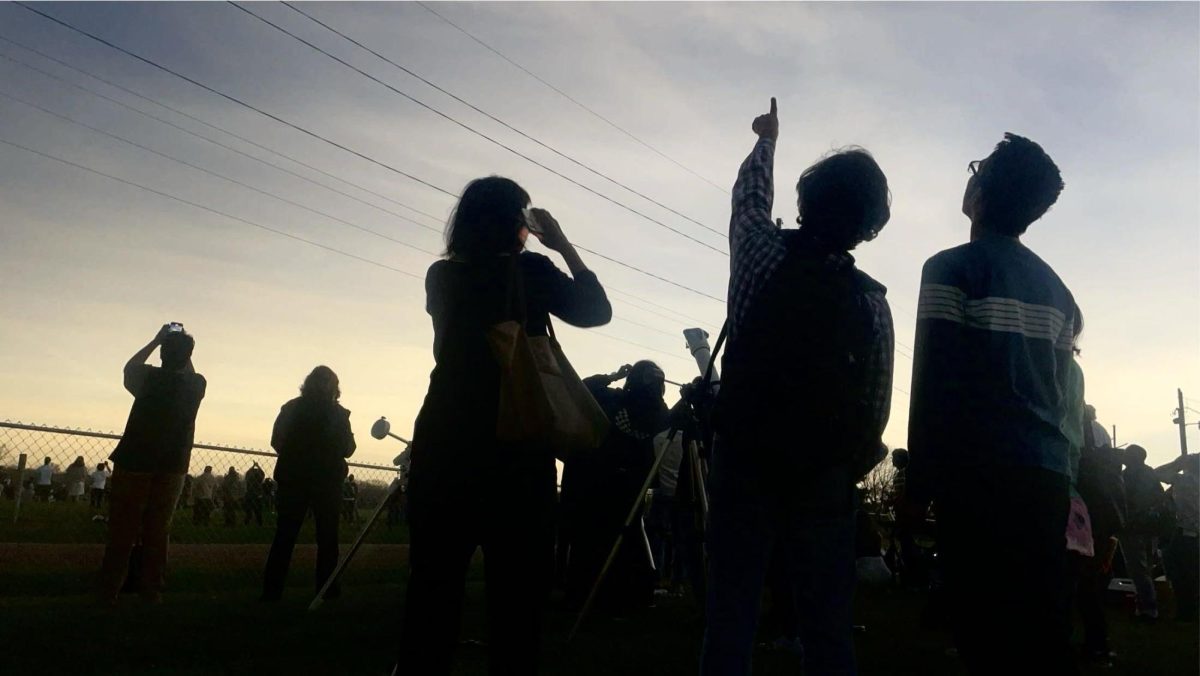 Viewers in Martinsville stare up at the solar eclipse Monday afternoon.
