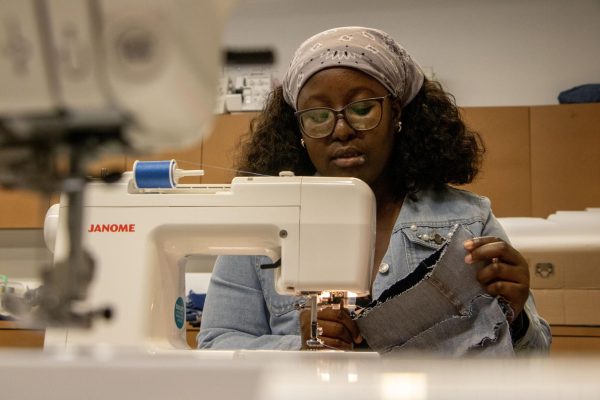 Samira Dadson sews a zipper onto denim in preparation for the denim day fashion shoot in the Doudna Fine Arts Center Fashion Lab, Charleston Ill., April 18, 2024. Dadson has been sewing for the past 10 years.