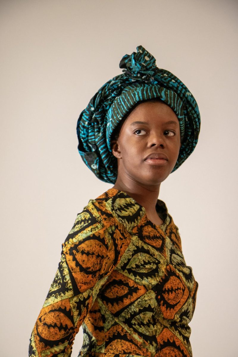 Model Aryanna Tunstall poses in a dress made by Master of Arts graduate student Samira Dadson as part of a collection on female empowerment in the Doudna Fine Arts Center, Charleston Ill., April 18, 2024. Tunstall’s dress is meant to represent modest dress in Ghana.