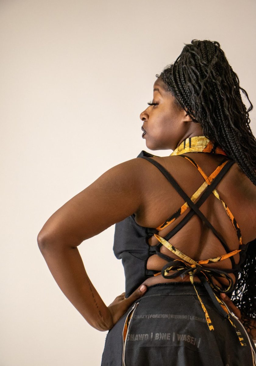 Alexis Moore-Jones poses wearing a dress made by Master of Arts graduate student Samira Dadson as part of a collection on female empowerment in the Doudna Fine Arts Center, Charleston Ill., Thursday afternoon, April 18, 2024. Moore-Jones dress represents immodest dress in Ghana. 
