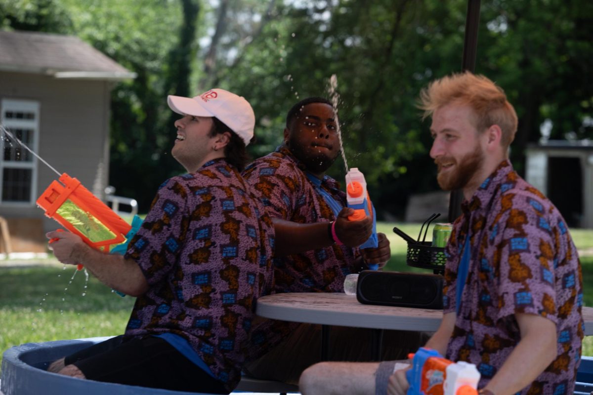 Three men in the Charleston 4th of July Parade shoot water guns at the audience on Polk Ave in Charleston, IL on July 4.