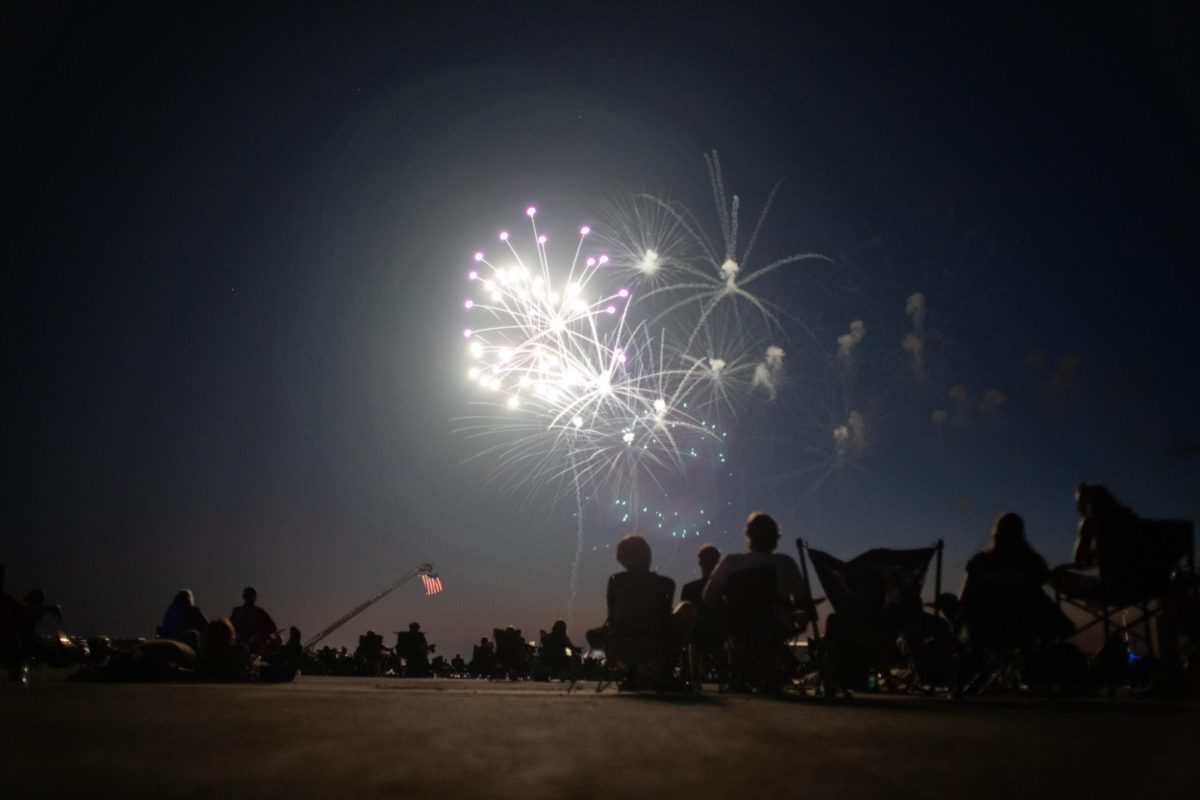The audience looks at a firework exploding in the sky at the Coles County Memorial Airport on July 4. 