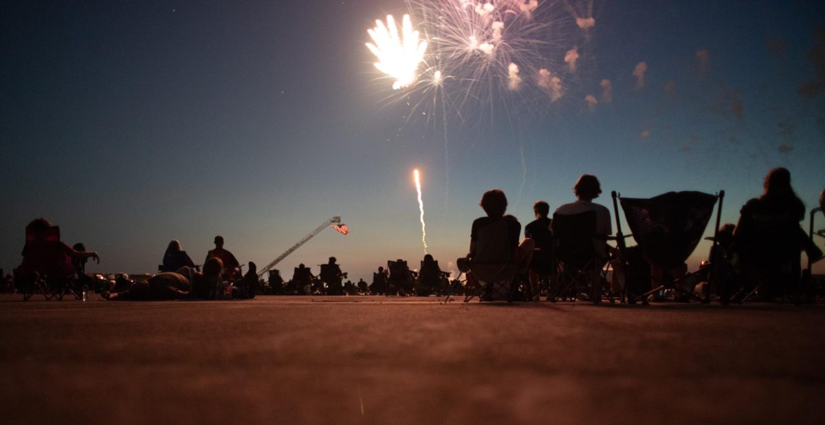 The audience looks at a firework exploding in the sky at the Coles County Memorial Airport on July 4, 2025.