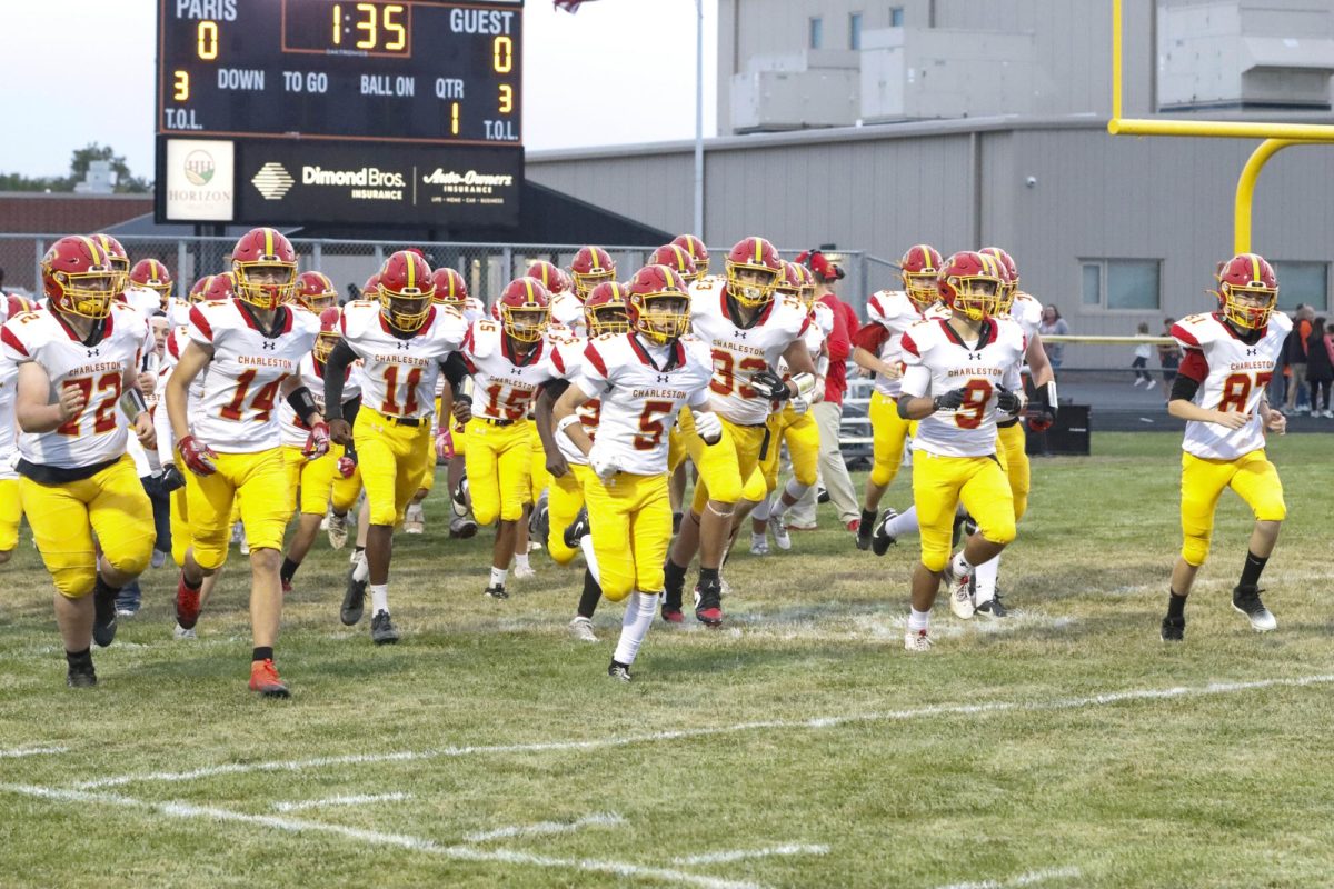 The Charleston High School Trojans run onto the field before their game against Paris High School as Charleston lost 48-14 at Paris High School on Friday.