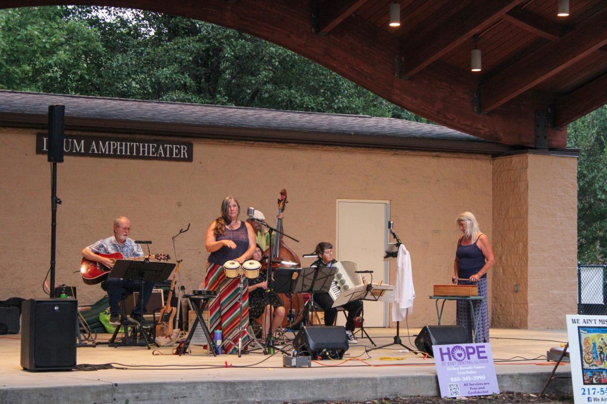 We Ain't Misbehavin' members Bob St. Gemme' (playing guitar), Yvonne Larson (playing bongos), Laura St. Gemme' (playing violin), Michael Brown (playing bass), Sarah Wiseman (playing accordion) and Karen Hart (playing percussion) perform for their audience in Kiwanis Park on Thursday.