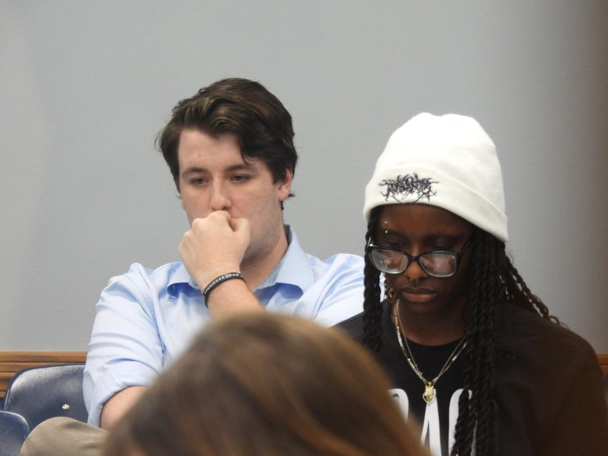 Student government association executive board members Vice President of Academic Affairs junior John Slater (left) and Executive Vice President sophomore Anna Jones (right) sit in the audience as they await the vote on their removal from office at an emergency meeting at the Arcola-Tuscola room in the Martin Luther King Jr student union on Sep. 22, 2025.