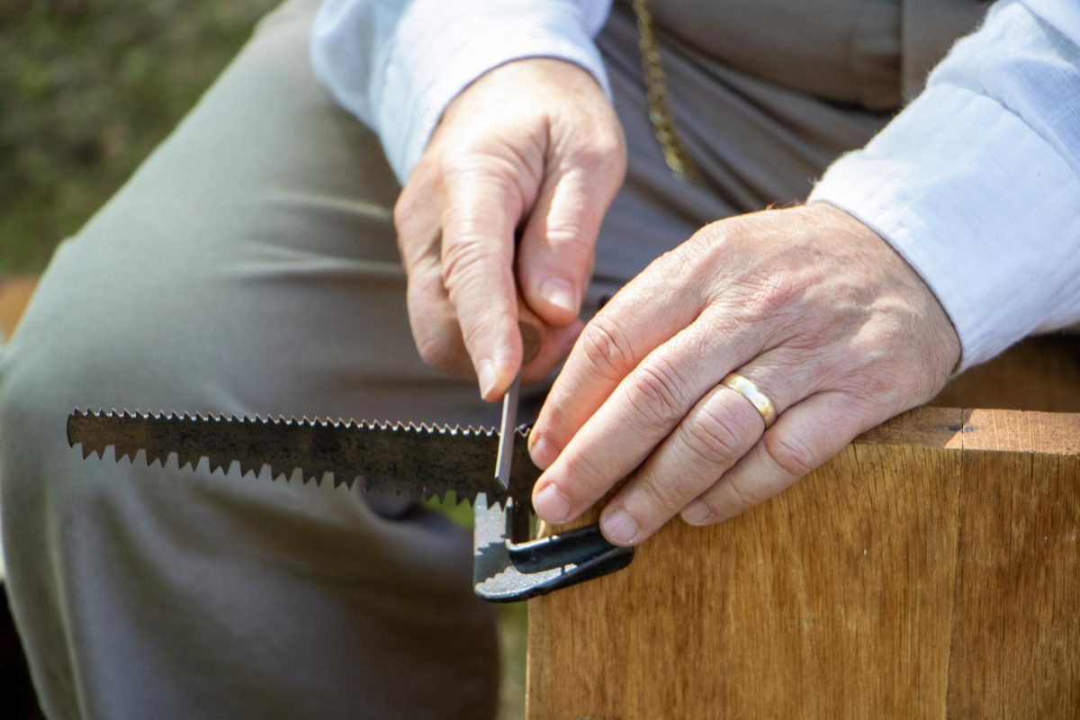 Woodworker Steve Vann sharpens his saw at Harvest Frolic on Sept. 28, 2025, in Lerna, ILL. Vann makes dulcimers, which are the earliest American string instruments, and zithers, the European equivalent that inspired the dulcimer. 