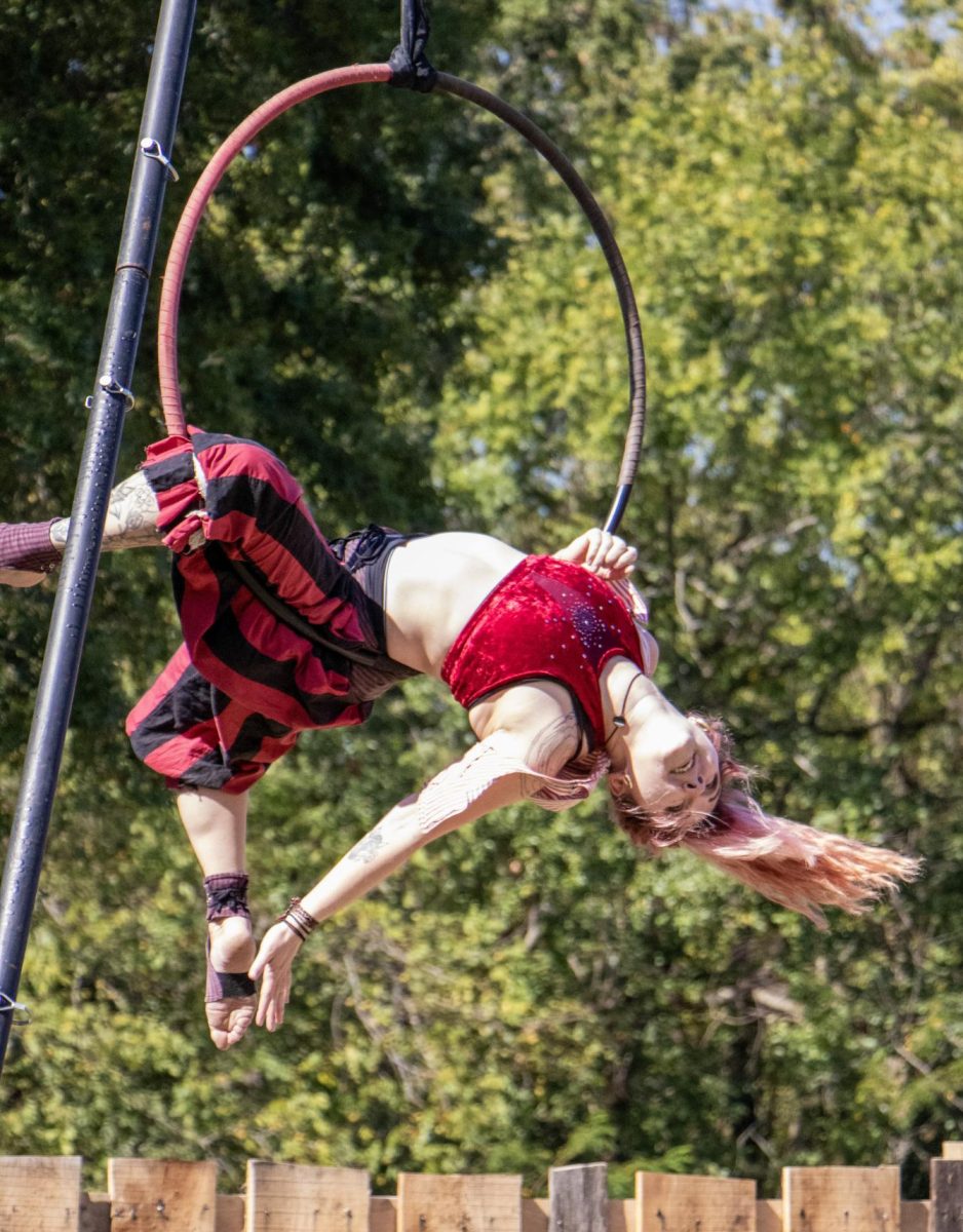 Pirate Tori LaDore (Tori Butts) spins from a hoop as part of the Knotty Bits Pirate Circus’ performance at Harvest Frolic on Sept. 28. She joined the group in 2024.  