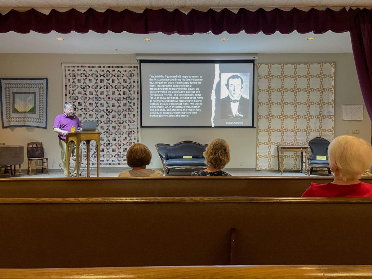 Samuel Wheeler gives a presentation with abolitionist lawyer, Hiram Rutherford in the slideshows during a presentation about the Matson slave trial which resulted in Illinois becoming a free state at the Lincoln Log Cabin on Saturday.