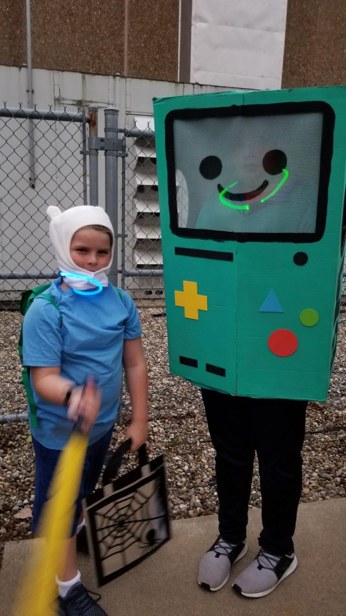 Emerson Reynolds, age 14, (Right) and his younger brother Felix Reynolds (Left) dress up as BMO and Finn from "Adventure Time" for Halloween.