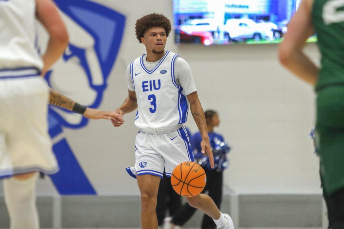 EIU men’s basketball junior guard Meechie White dribbles up the court and relays an offensive play during EIU's 62-50 win over Tiffin University at Groniger Arena on Wednesday.