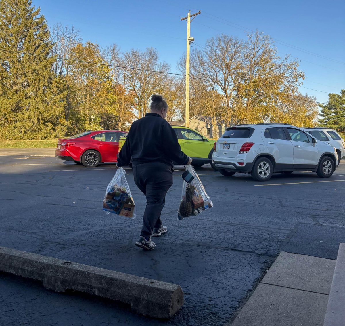 Ashton Systo, a SNAP program recipient, packs bags of food into her car at the Charleston Area Church’s Food Pantry after SNAP got cut by the federal government on Wednesday.