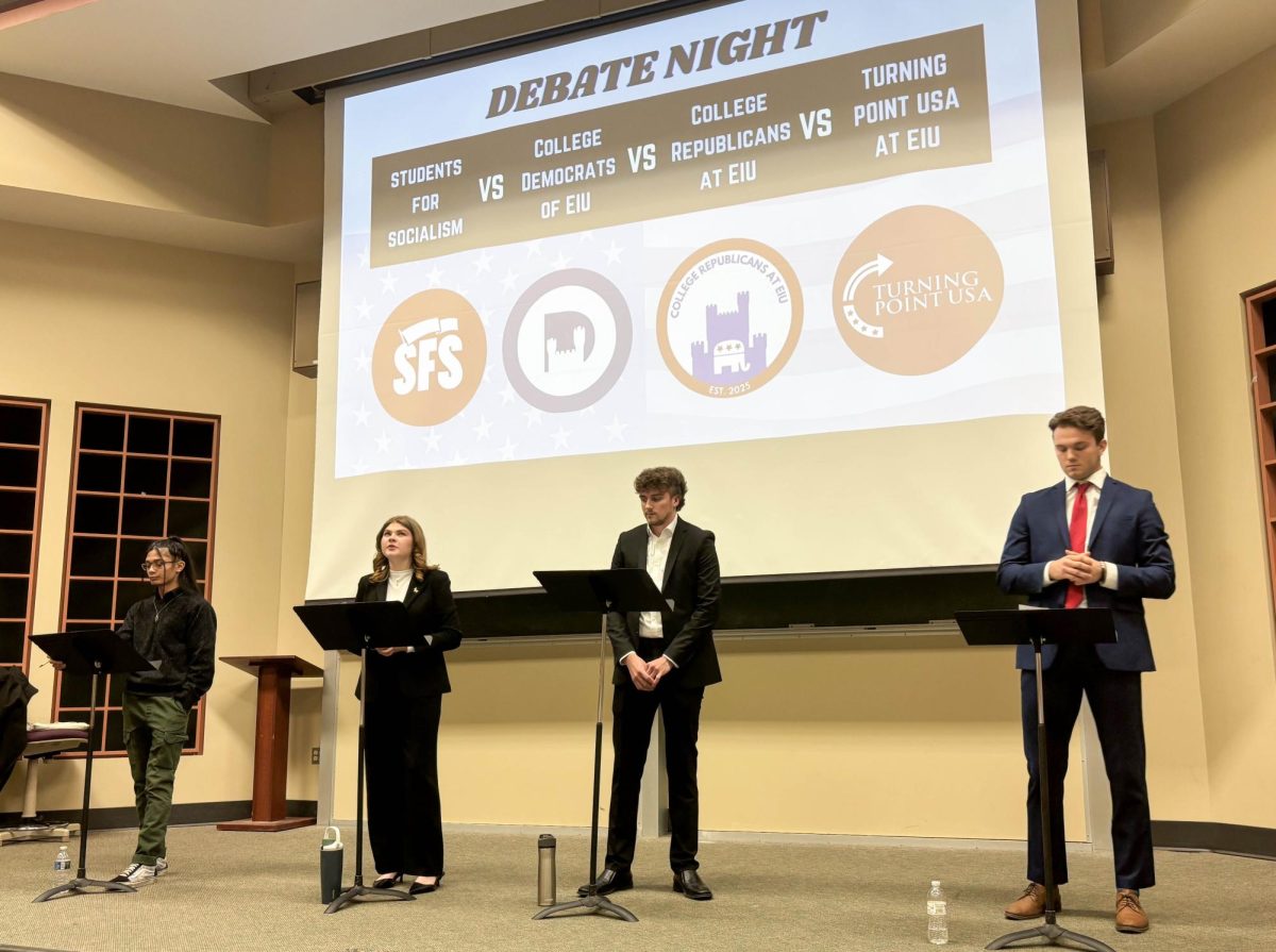 During the Tuesday night debate, from left to right, SFS President Jason Farias, EIU College Democrats President Megan Fox, EIU College Republicans President Ben Anderson and Turning Point USA Vice President James Geshel debate against one another in the Buzzard Auditorium.