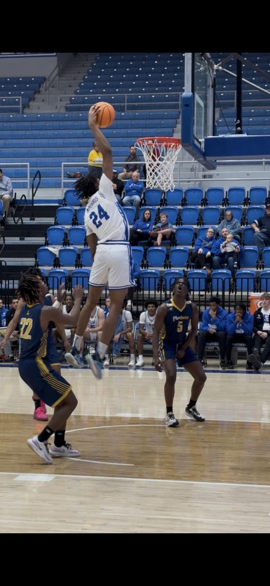 Sophomore forward Terry McMorris getting up for a fast break dunk in EIU's 110-56 win against East-West University Monday afternoon at Groniger Arena.