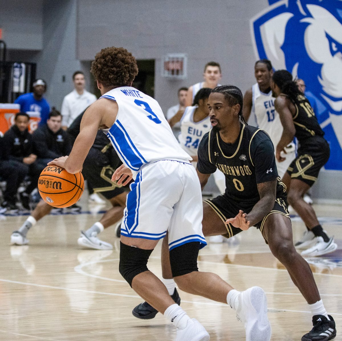 EIU men’s basketball sophomore forward Terry McMorris dribbles the ball while being defended against Lindenwood junior Mekhi Cooper (left) and getting chased by junior Robert Lewis during Eastern's 82-74 loss to Lindenwood at Groninger Arena on Saturday.