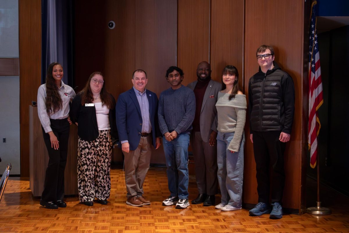 Martin Luther King Jr. community breakfast panel speakers stand alongside and pose with EIU President Jay Gatrell and John Blue, executive director of the office of belonging, access and engagement. 