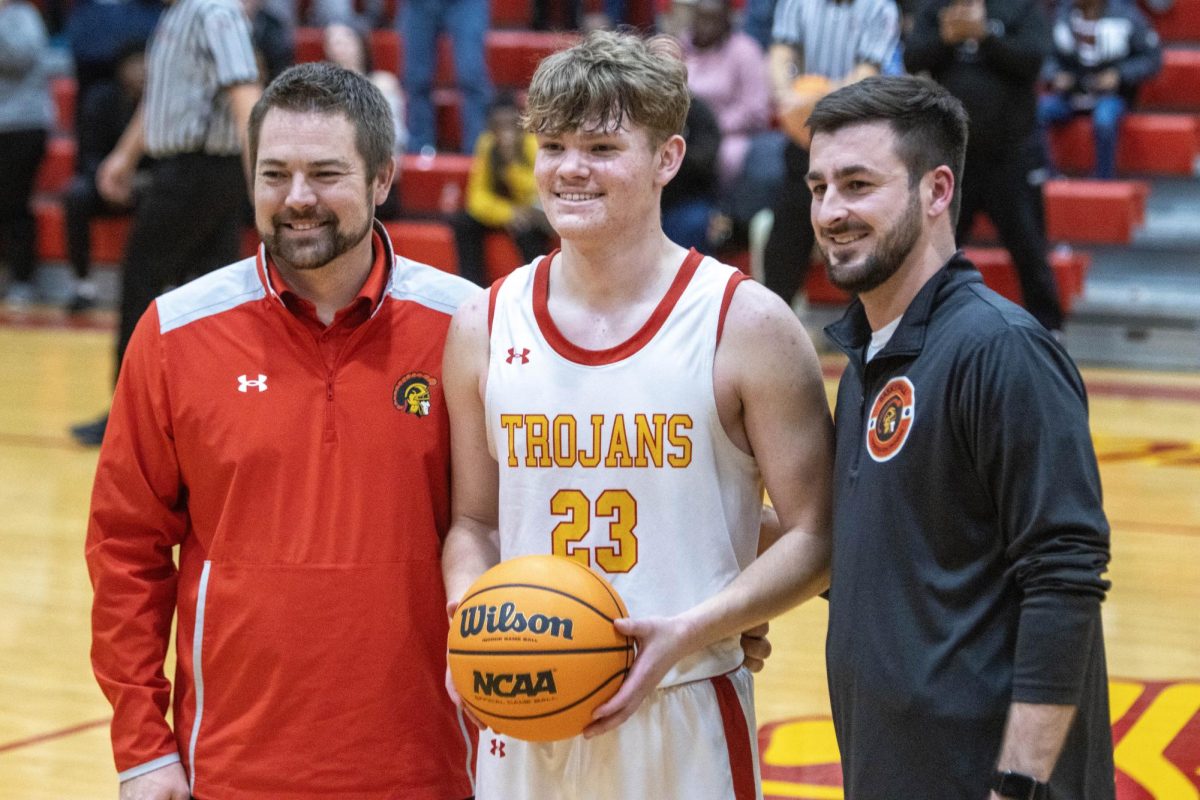 Senior guard Tyler Oakley (center) poses with head coach Colin McInerney (right) and athletic director Brian Deadmond (left) after breaking the Charleston all-time scoring record.