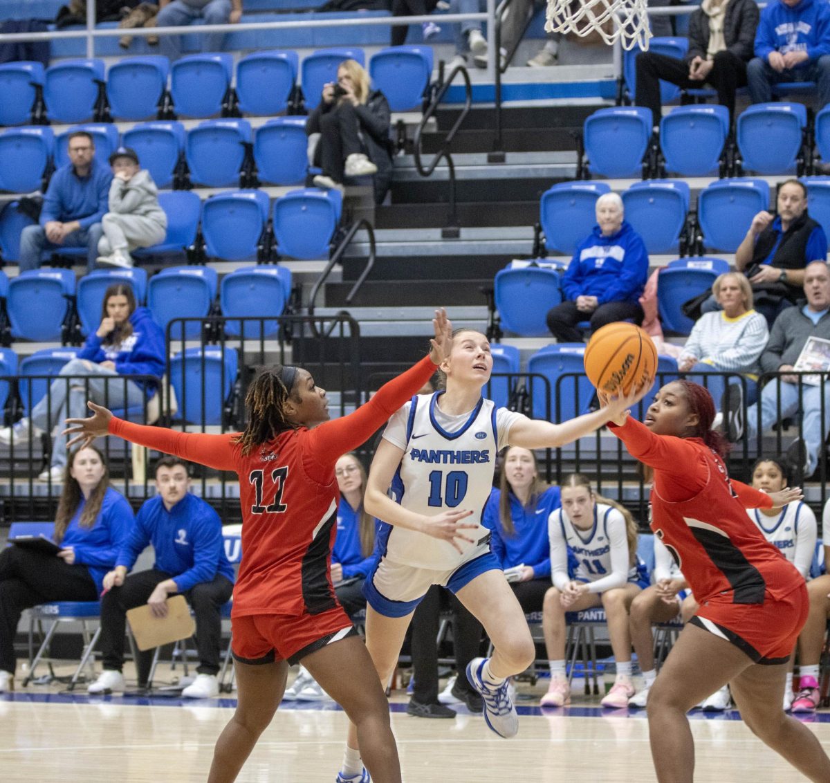 Redshirt sophomore Adriana Arroyo throws up a shot in desperation to attempt to cut the lead down against Southeast Missouri State.  Arroyo is defended by graduate student guard Lexi McCully (left) and junior center Aa'Mya Stacker (right) as EIU lost 71-56 at Groniger Arena on Saturday.