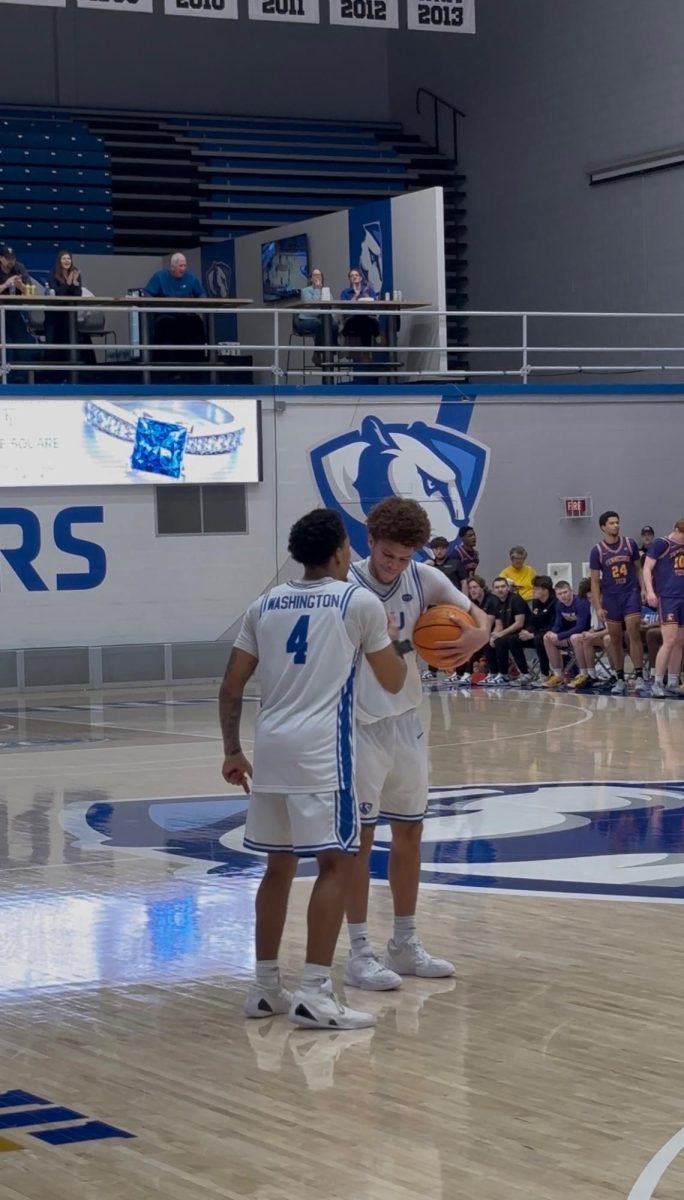 Junior guard Meechie White and graduate guard Andre Washington celebrate after Eastern's 71-61 win over Tennessee Tech Thursday evening at Groniger Arena.