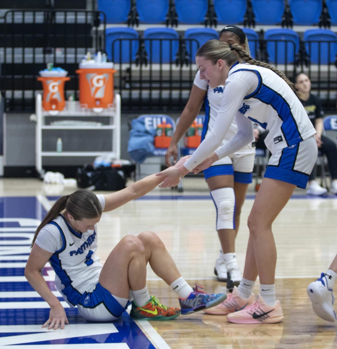 Ella Lune helps Ava Stoller up after a failed shot during Friday's game on Thursday against Morehead State. The Panther's would lose 74-70.