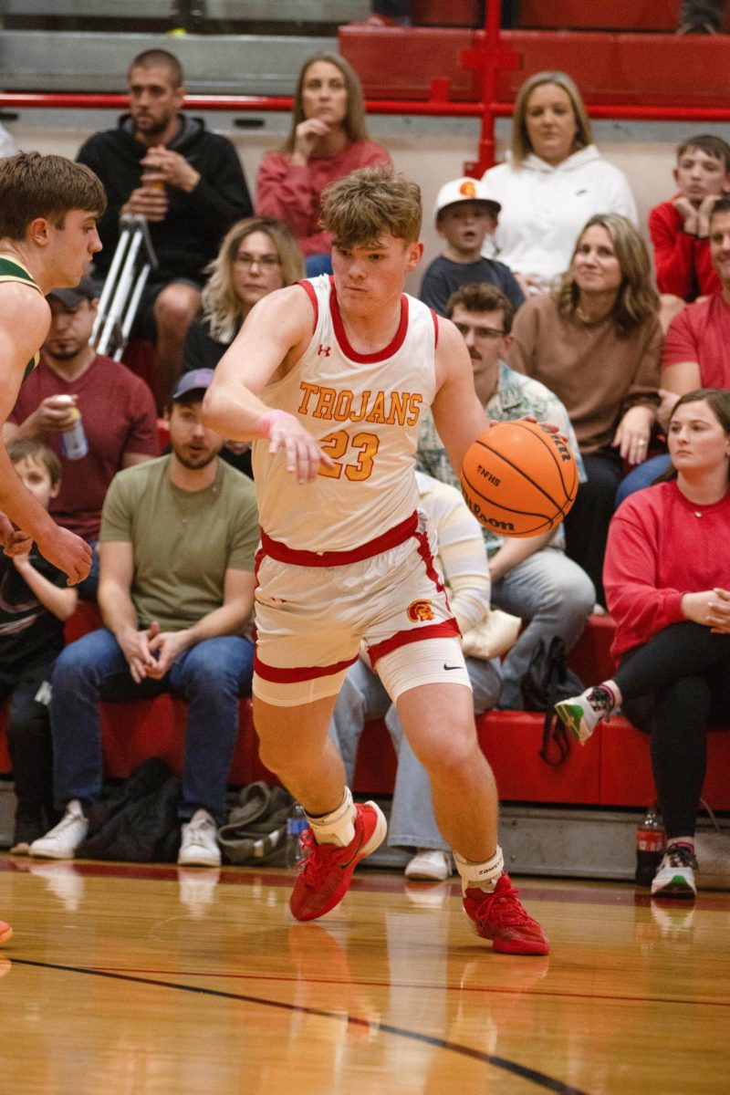 Charleston High School senior forward Tyler Oakley dribbles left while being guarded by Mattoon High School junior forward Tyler Haacke during the Trojans 66-32 loss to Mattoon Tuesday night at Baker Gym.