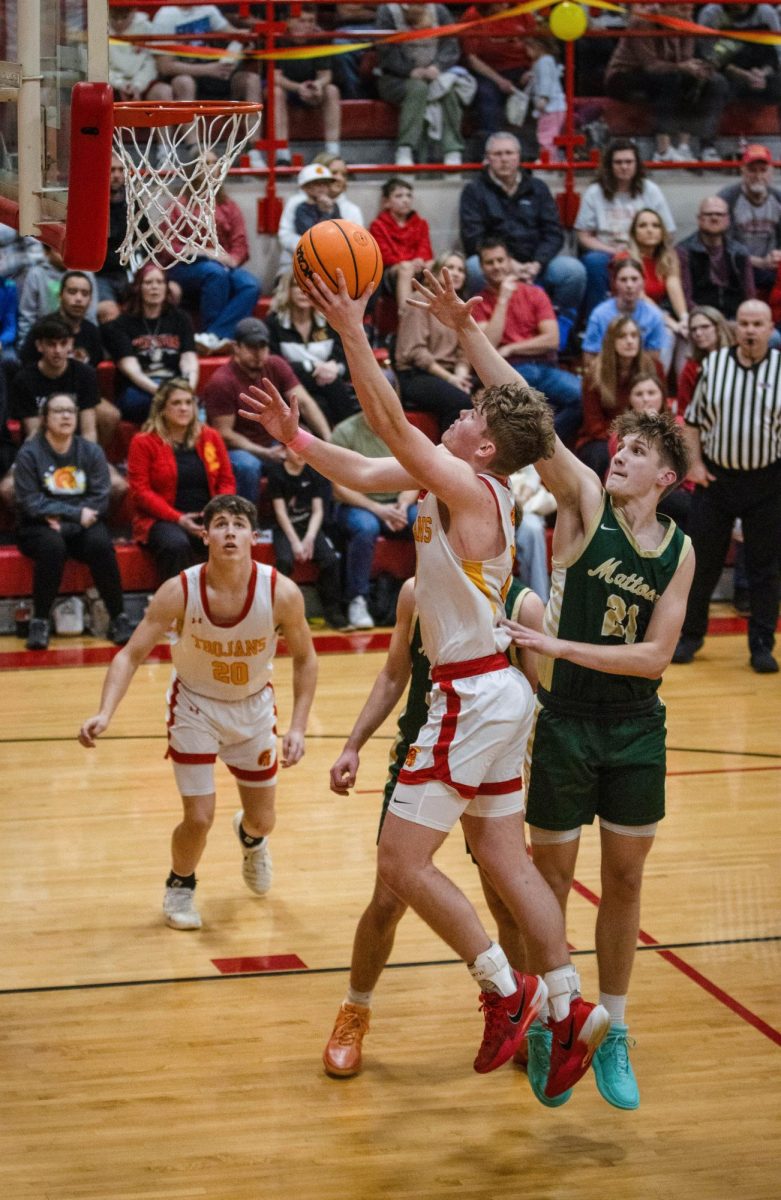 Charleston High School senior forward Tyler Oakley goes up for a layup during the Trojans 66-32 loss to Mattoon Tuesday night at Baker Gym.