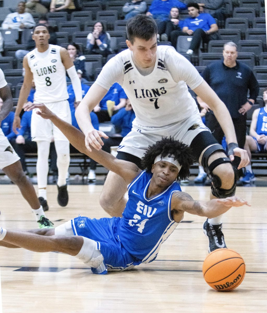 Sophomore forward Terry McMorris reaches and fights for a loose ball with Lindenwood center Milos Nenadic during EIU men's basketball's 71-67 win over Lindenwood at Hyland Arena in St. Charles, Missouri, on Thursday.