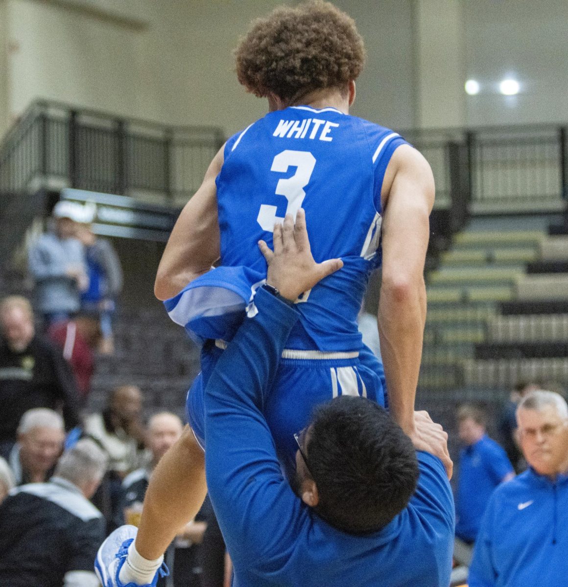 Junior guard Meechie White (top) gets lifted up by graduate assistant Carlos Cortez Jr. (below) after EIU men's basketball's 71-67 win over Lindenwood at Hyland Arena in St. Charles, Missouri on Thursday.