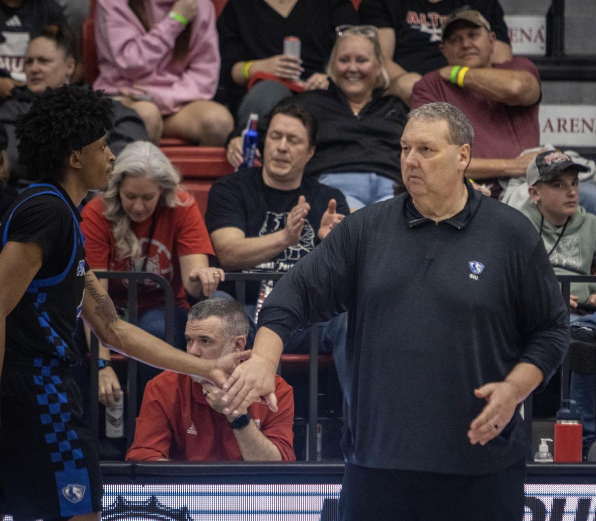 Head coach Marty Simmons (right) high-fives sophomore forward Terry McMorris (left) during EIU men’s basketball 77-50 lost against SIUE at First Community Arena in Edwardsville on Saturday.