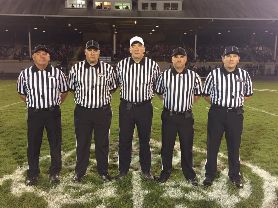 From left to right: Chris Hartbank, Mike Nichols, Add Owen, Dave Purvis, and Matt Brown post for a picture during an IHSA state quarterfinal game at Peoria High School between Peoria and Joliet Catholic in 2024. 
