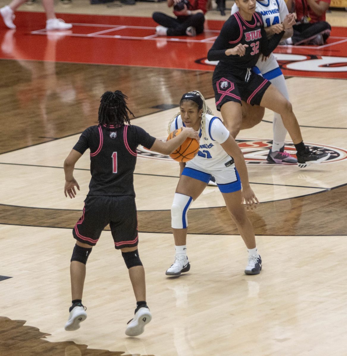 SIUE freshman guard Kiyoko Proctor gets picked up defensively by EIU senior guard Tiny Lewis in the first half of Eastern women’s basketball 70-43 lost against SIUE at First Community Arena in Edwardsville on Saturday.