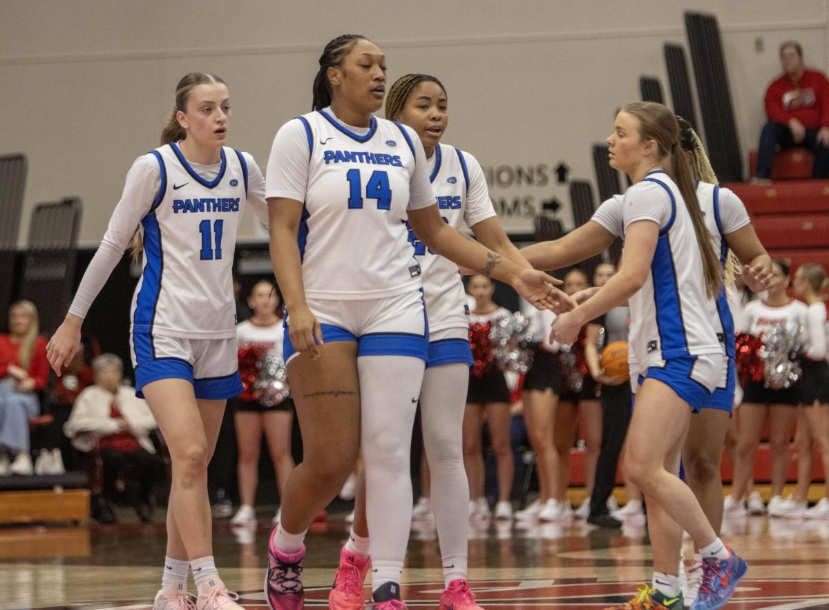 EIU women's basketball players walk back to their bench during a time out in the first half of Eastern women’s basketball 70-43 lost against SIUE at First Community Arena in Edwardsville on Saturday.