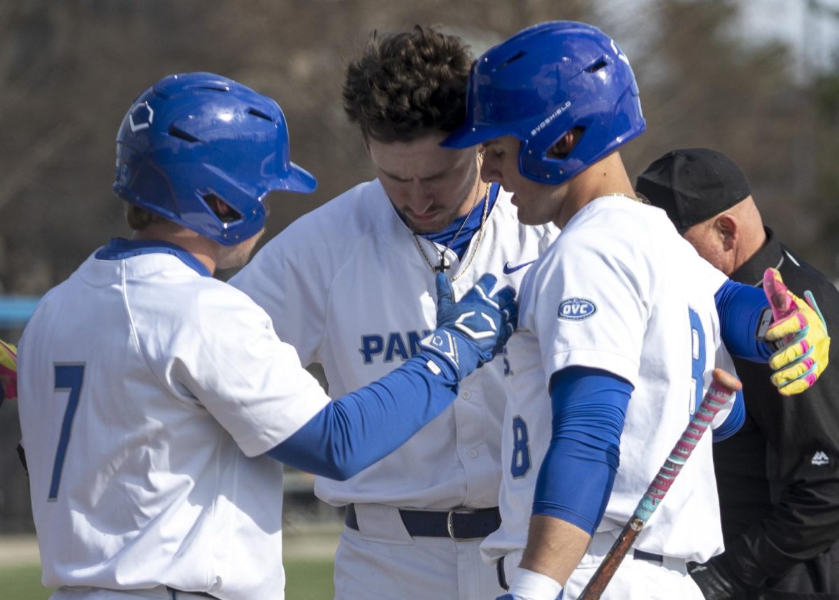 Sophomore infielder James Love hugs graduate infielder Peyton Wilson and redshirt senior outfielder Joey Hagen after hitting a home run in the first inning of EIU baseball's series opener against Morehead State Friday at Frost Field at Coaches Stadium.