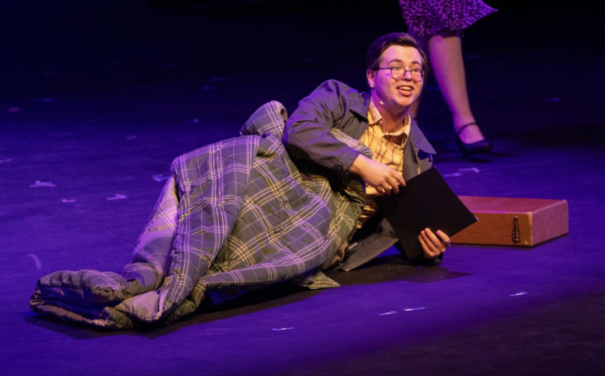 Billy Cane, played by Gentry Copsy, lays outside of The Asheville Southern Journal to showcase the character’s dedication of getting his writing published in the musical, Bright Star. Bright Star occurred from Friday, Feb. 27, 2026 until Sunday, March 8, 2026  in Doudna Fine Arts Center.