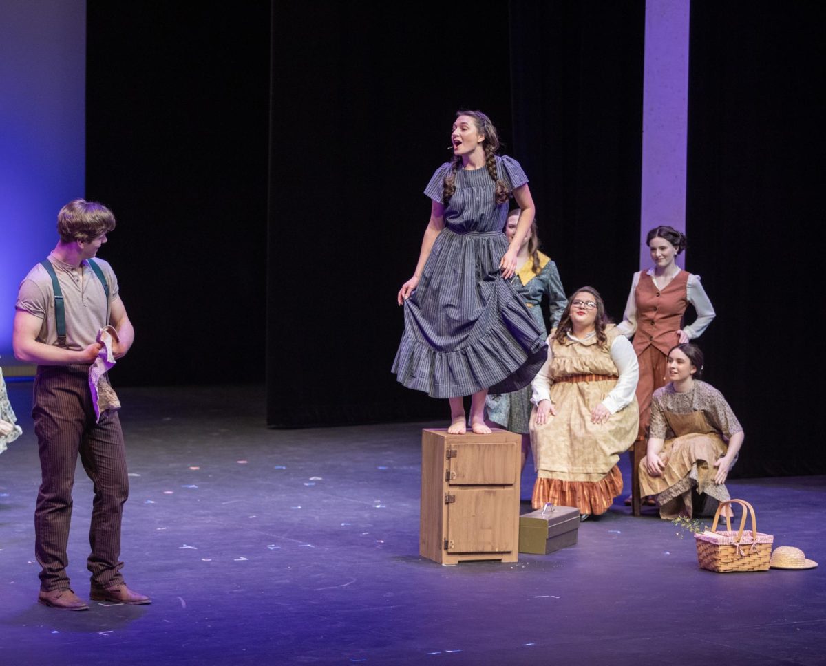 Alice, played by Bri Olshawsky, talks to Jimmy Ray, played by Mitch Cox, dance during the song, “Whoa, Mama” in the musical, Bright Star. Alice dances on top of an icebox, which Jimmy Ray was previously fixing for Alice’s family. Bright Star occurred from Friday, Feb. 27, 2026 until Sunday, March 8, 226 in Doudna Fine Arts Center.