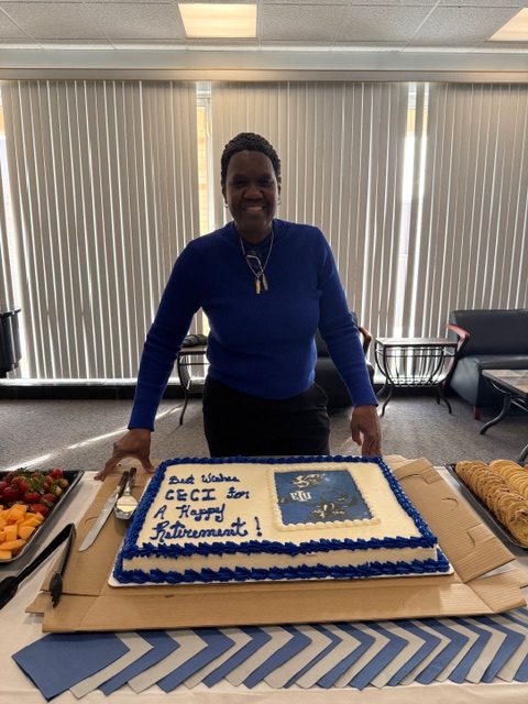 Retiree Ceci Brinker stands by her cake during at her retirement party on Wednesday, Jan. 28 in the Martin Luther King Jr. Union.