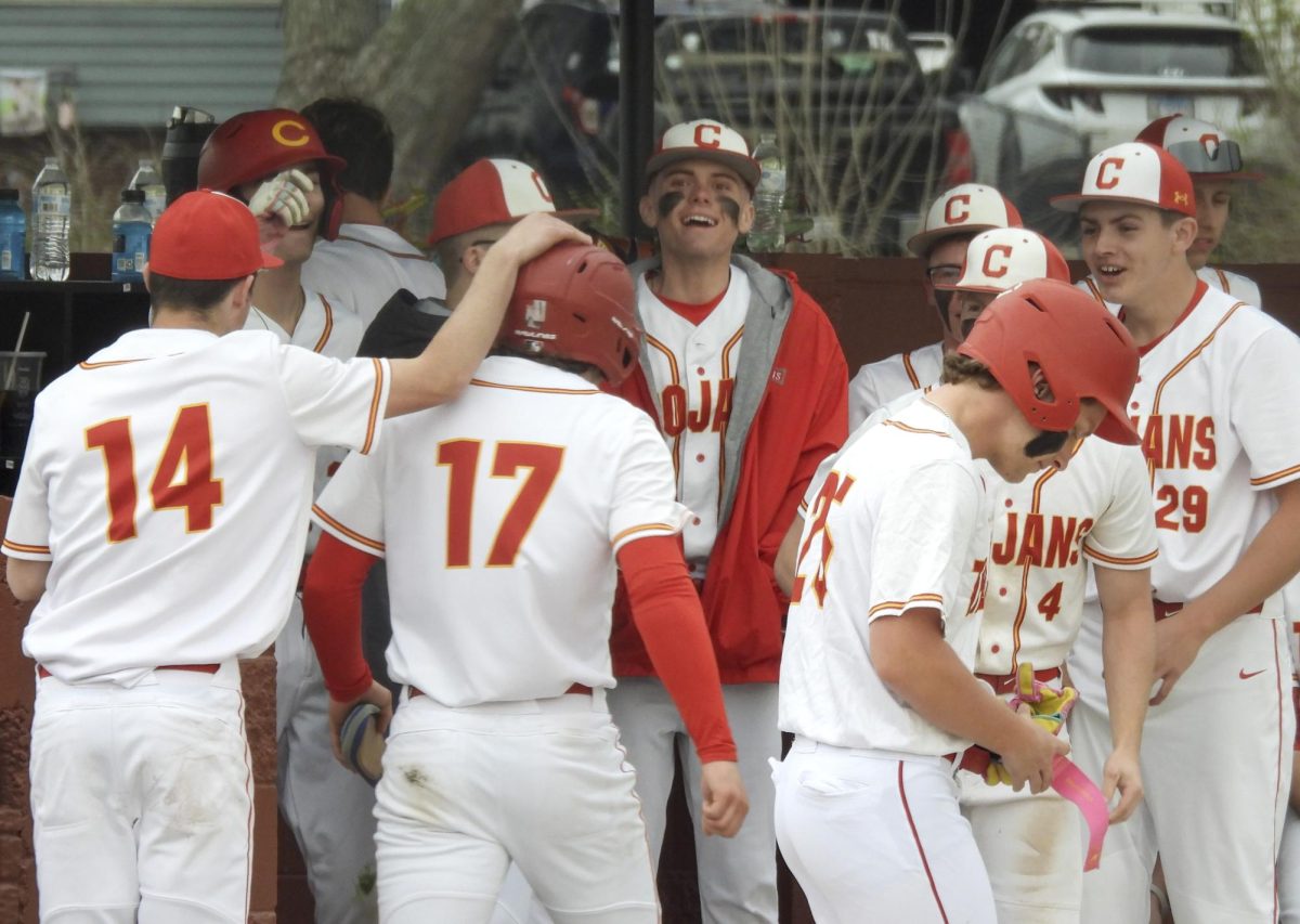 The Charleston High School baseball team celebrates after an Alex Matheny RBI in the fourth inning in the trojans game against Salem High School on Wednesday at Charleston High School.