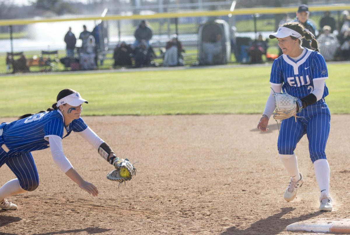 EIU Softball sophomore infielder Abbi Hatton (left) dives to first base while freshman utility player Adysen Rios (right) stands on first for the final out in a 12-9 EIU win against Lindenwood at Williams field on Saturday.