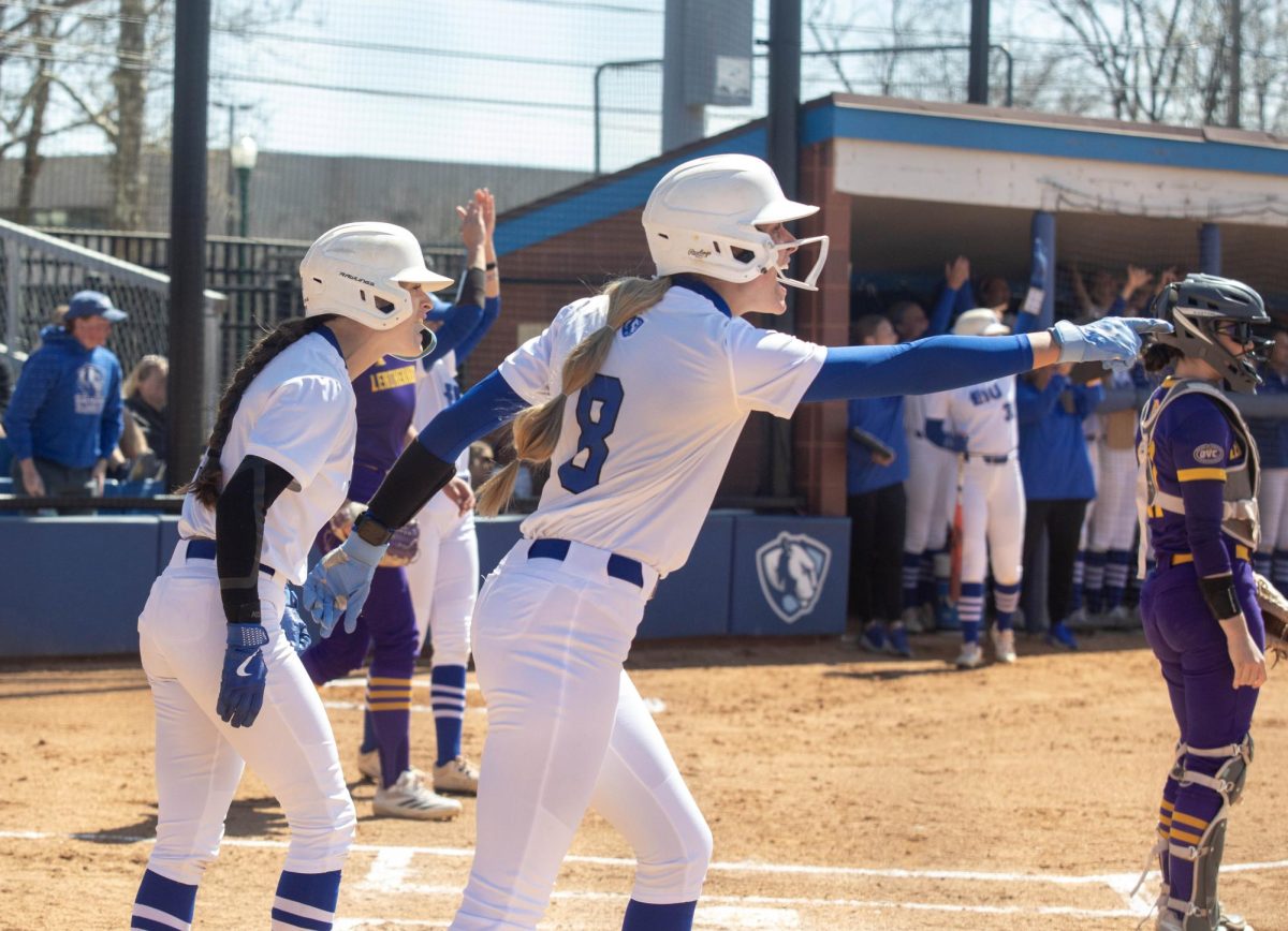 Freshman outfielder Brooklyn Groppel (right) points out and yells to her teammate at second with junior catcher Sophia Olman (left) as they both score during EIU softball’s 7-4 win over Western Illinois at Williams Field on Sunday.
