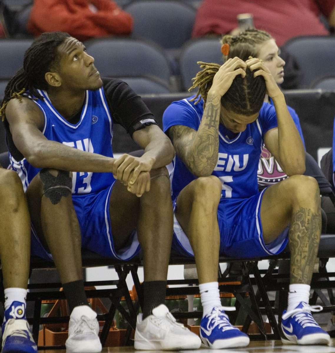 Senior guard Zion Fruster (right) and fifth-year forward Nazareth Fisher (left) sit on the bench during EIU men’s basketball’s 66-63 loss to UT Martin in the OVC Conference Tournament quarterfinals at the Ford Arena in Evansville, Indiana, on Thursday.