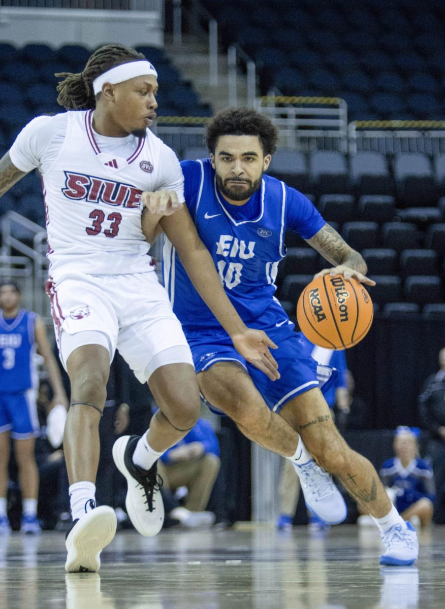 Redshirt junior guard Preston Turner drives against SIUE guard Jo Valrie during EIU men’s basketball’s 77-71 overtime win over five-seed SIUE in the OVC conference tournament at the Ford Center in Evansville, Indiana, on Wednesday.