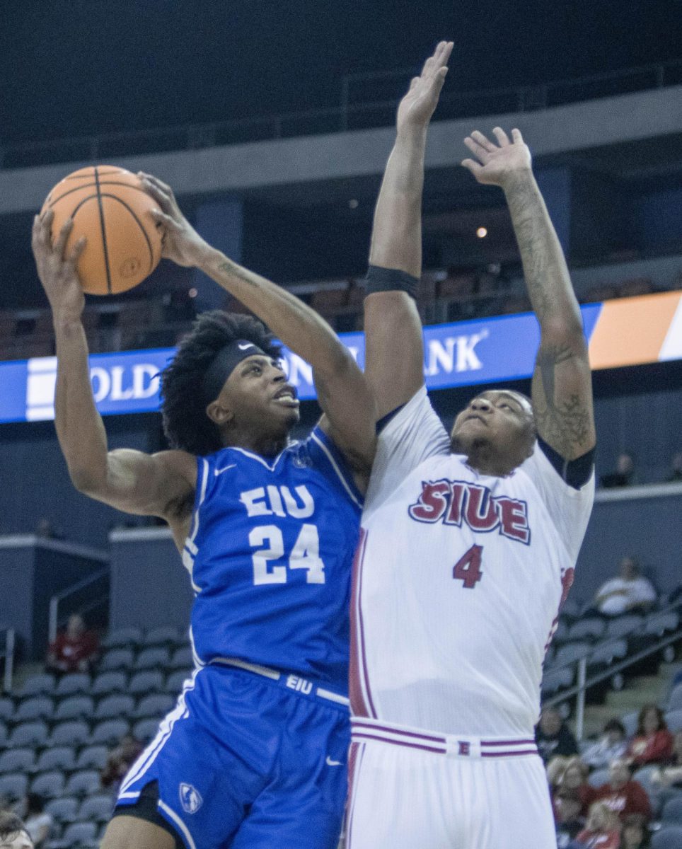 Sophomore forward Terry McMorris takes a layup over SIUE forward Darrion Baker during EIU men’s basketball’s 77-71 win over five-seed SIUE in the OVC conference tournament at the Ford Center in Evansville, Indiana, on Wednesday.