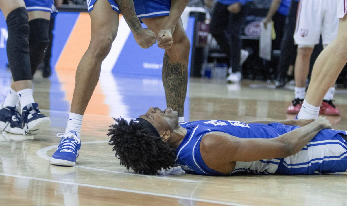 Sophomore forward Terry McMorris yells on the ground after an and-1 layup during EIU men’s basketball’s 77-71 win over five-seed SIUE in the OVC conference tournament at the Ford Center in Evansville, Indiana, on Wednesday.