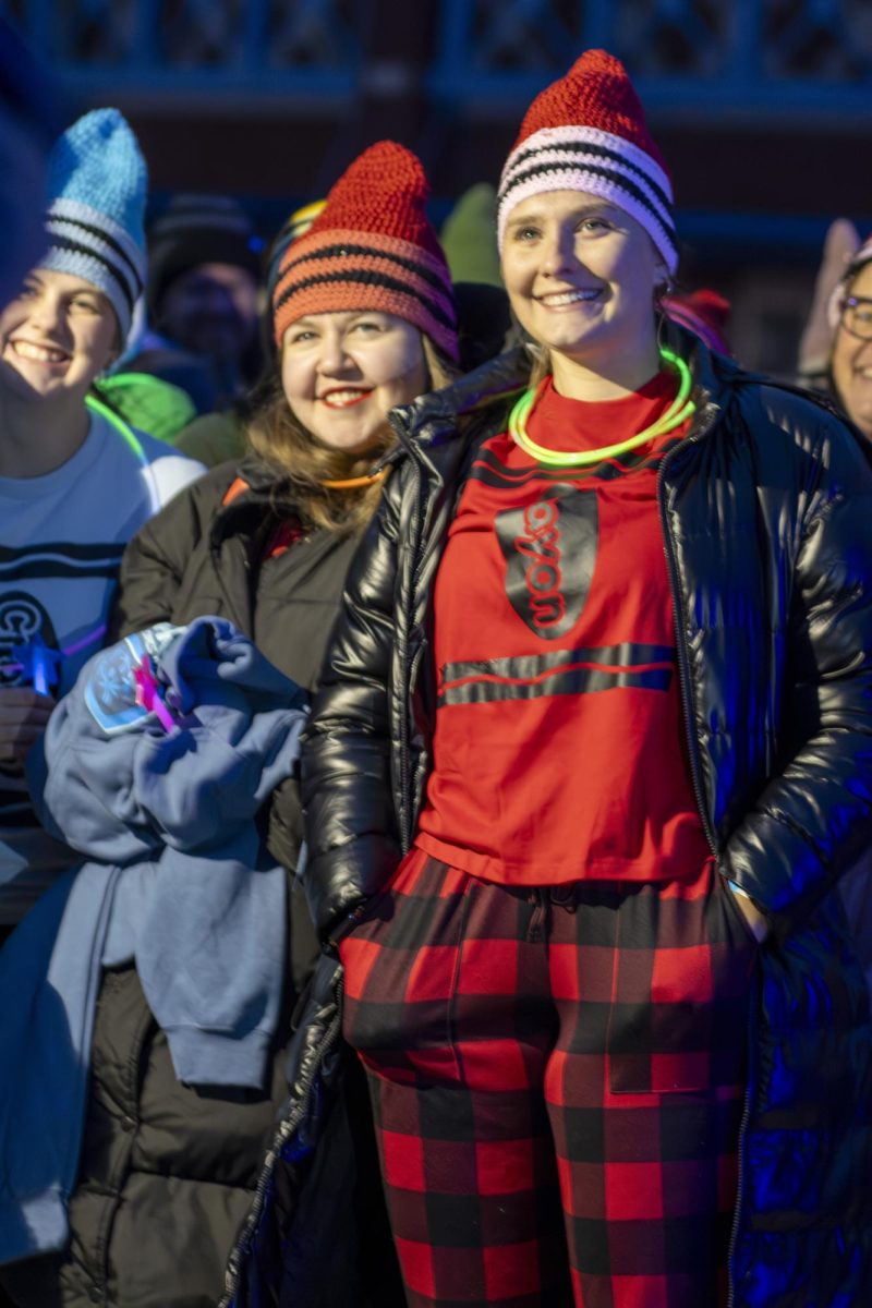 EIU special education students, Bella Braden (left), Emily Boyd (center) and Abby Cowell (right) pose for pictures with the rest of the department before the Polar Plunge began outside of O'Brien Stadium on Sunday.