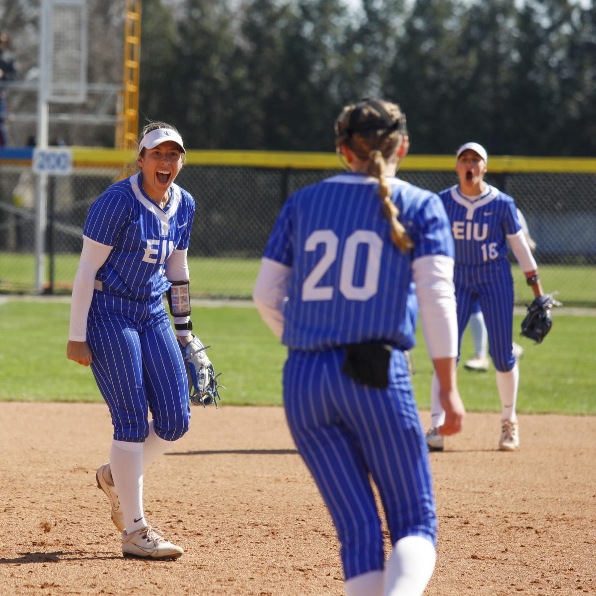 Eastern Illinois softball senior infielder Lizzie Stiverson (left) yells to sophomore pitcher Rylan Gick (right) after getting an out during EIU softball’s 3-2 win over Western Illinois at Williams Field on Saturday.